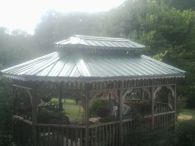 Two tier green metal roof on a garden gazebo in Magnolia